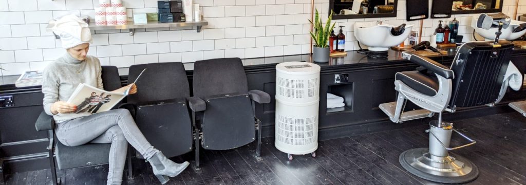 Rensair hospital-grade air purifier in a barber with person